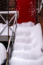 After A Blizzard The Steps Up To A Red Back Door Are Covered With Soft Drifed Snow.  Shot In Toronto’s Beaches In January.  Room For Text.