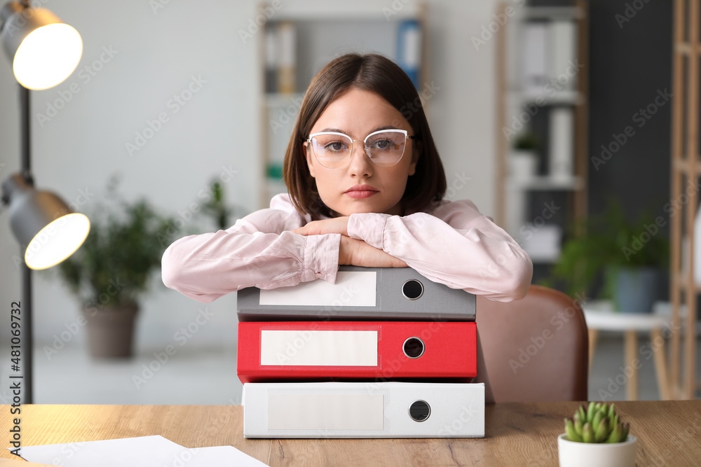 Young woman working with documents in office