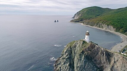 Wall Mural - Aerial view of an old lighthouse on the cliff on pacific coast. Beautiful panoramic seascape