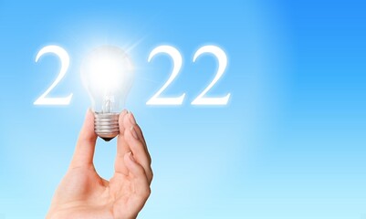 Wall Mural - Idea and creative in 2022 text, lighting bulb with new year number on blue background