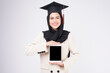 © tonefotografia - Young muslim woman graduated over white background studio..