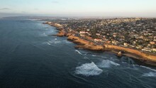 Aerial View Of San Diego Cliffs, Affluent Suburbia And Coastline With Pacific Ocean Waves, California USA, High Rise Drone Shot