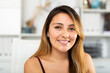 Portrait of young smiling latina business woman in office
