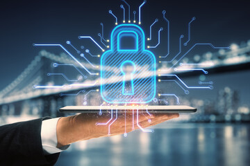 Fototapete - Close up of businessman hand holding tablet with abstract glowing padlock hologram on blurry night city background. Safety and digital security concept. Double exposure.