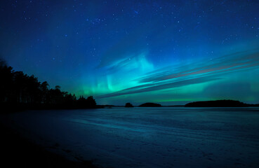 Wall Mural - northern light dancing over frozen lake in north of sweden,