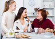© JackF - Three generations of happy family enjoying conversation over cup of coffee at home