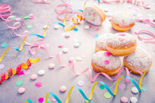 Traditional Berliner For Carnival And Party. German Krapfen Or Donuts With Streamers And Confetti.
