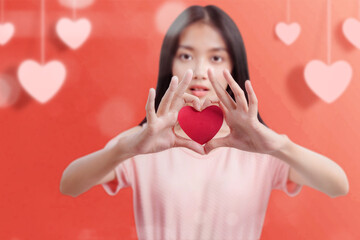 Poster - Asian woman holding the red heart