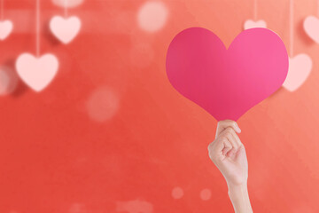 Poster - Hand holding hearts with a colored background