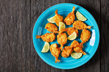 Wall Mural - Crispy Fried Butterfly Shrimp on a blue plate