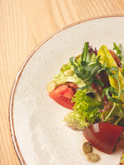 Wall Mural - Mix salad with fresh vegetables on plate closeup