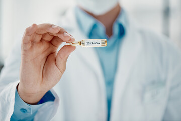 Poster - It's finally here. Cropped shot of a scientist holding an ampoule with 2019-nCov on it.