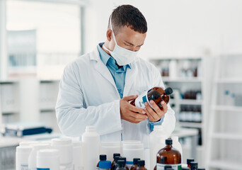 Poster - Unmasking the virus. Shot of a young scientist analysing medication in a laboratory.