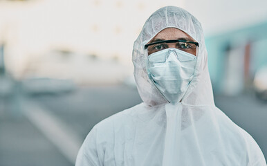 Poster - It's us versus the virus. Shot of a young man dressed in his protective gear before the decontamination process.