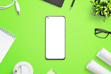 Poster - Phone mockup on greed work desk surrounded with office suplies, project papers, pens, plants, pad, coffee, plant. Isolated screen for mockup