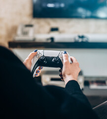 Woman's Hands holding a wireless gamepad. Concept games, video games