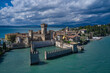 Rocca Scaligera Castle in Sirmione. Aerial photography with drone. Aerial view on Sirmione sul Garda. Italy, Lombardy. Cumulus clouds over the island of Sirmione.