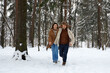 © Georgii - People, season, love and leisure concept - happy couple hugging and laughing outdoors in winter. Couple embracing and having fun in snowy winter park