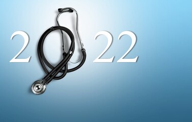 Wall Mural - 2022 number with stethoscope. Happy New Year for heart health and medical concept,