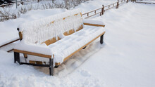Snow-covered Bench Sunk In The Snow, A Large Amount Of Precipitation In Winter