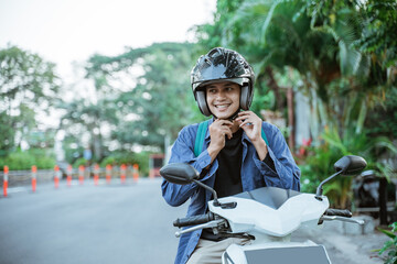 Man getting ready to wear helmet before going on motorbike