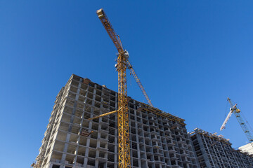 Poster - Residential building construction process. Facade of a modern apartment building under construction.