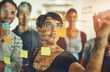 © Cecilie Skjold Wackerhausen/peopleimages.com - Exploring new possibilities. Cropped shot of a group of young designers using sticky notes during a brainstorming session.