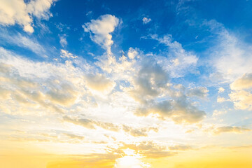 Wall Mural - Sky blue and orange light of the sun through the clouds in the sky