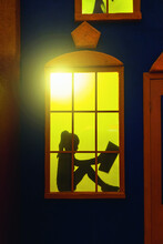 Silhouette Of A Girl Outside The Window Reading A Book