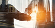 © Thurstan H/peopleimages.com - City deals in the making. Multiple exposure shot of two businesspeople shaking hands superimposed on a cityscape.