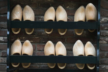 A Close-up  Of Wooden Shoes In A Rack
