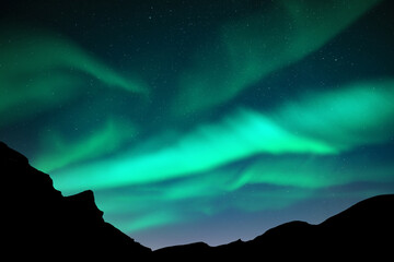 Wall Mural - aurora borealis. northern lights in winter mountains. sky with polar lights and stars
