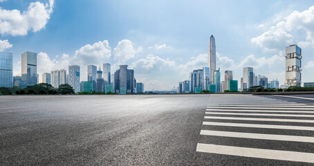 Asphalt road and city skyline with modern commercial office buildings in Shenzhen, China.