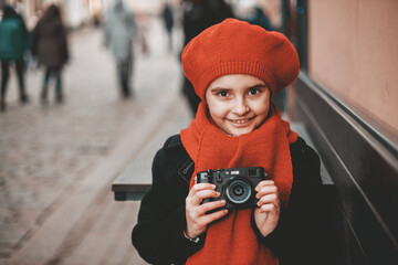 Poster - young girl photographer in red beret with camera