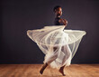 © Mapodile M./peopleimages.com - Poetry in motion. Young female contemporary dancer using a soft white white skirt for dramatic effect.