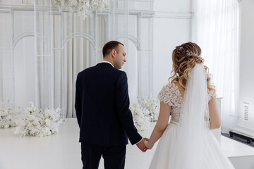 Wall Mural - Newlyweds swear allegiance to each other. Celebration in the White Hall. Congratulations to the young. Significant day.