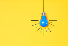 Concept Creative Idea With Lightbulb On Yellow Background
