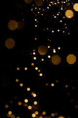 Abstract orange and gold dark background with glowing turquoise particles.