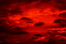 Bright Red Sunset. Dramatic Evening Sky With Clouds. Fiery Skies With Space For Design. Magic Fantasy Sky. War, Battle, Terror, World Apocalypse, Horror Concept.
