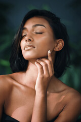 Canvas Print - sparkle with all your heart. shot of a beautiful young woman posing against a dark background.