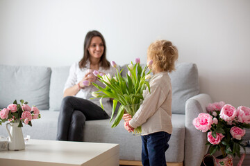 Canvas Print - Beautiful blond boy, giving mother flowers and box with little gift for mothers day