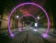 Fantastic View Of The Street Of The Night City With Luminous Lilac Rings Of Portals