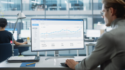 Poster - Close Up Over the Shoulder Shot of a Businessman Working on Desktop Computer with Finance Statistical Data Software. Digital Projects Manager Typing Data, Using Keyboard and Mouse.