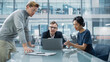 © Gorodenkoff - Multiethnic Diverse Office Conference Room Meeting: Team of Three Creative Entrepreneurs Talk, Discuss Growth Strategy. Stylish Young Businesspeople work on Digital e-Commerce Startup Project.