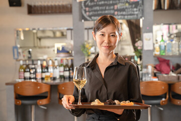 Wall Mural - 飲食店でワインを提供する女性スタッフ