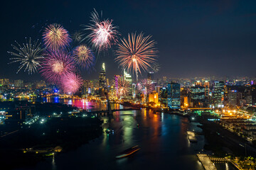 Wall Mural - Celebration. Skyline with fireworks light up sky over business district in Ho Chi Minh City ( Saigon ), Vietnam. Beautiful night view cityscape.