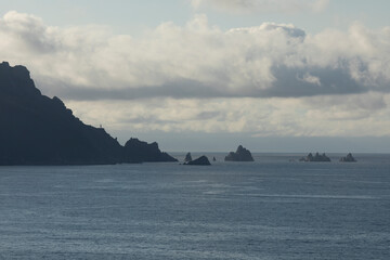 Sunset and seascape with Cape Ortegal on the background, last lights, and cliffs, in front of the Garita da Vela viewpoint, from Espasante, council of Ortigueira, Galicia, Spain