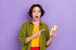 Photo of young astonished lady indicate finger mobile comment decision 4g isolated over violet color background