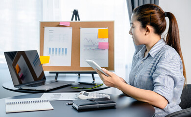 Poster - Business woman holding tablet to checking email and reply information to boss while looking on laptop screen