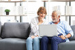 © offsuperphoto - senior couple using laptop computer on sofa